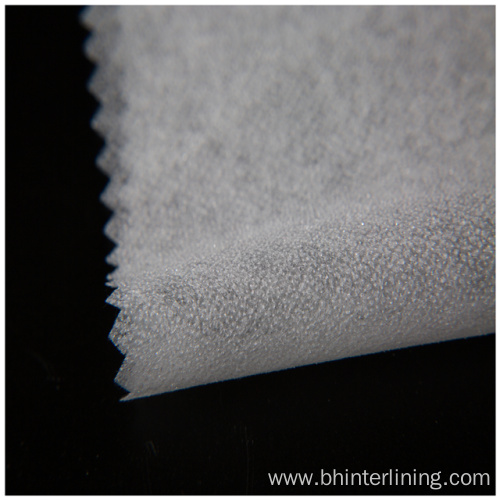 Soft and smooth feeling fusible nonwoven interlining fabric